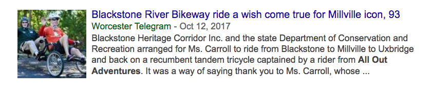 2 women smile and wave as they ride a recumbent trike; "Blackstone River Bikeway ride a wish come true for Millville icon, 93"
