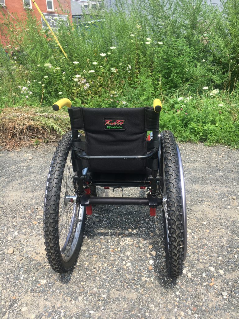 Back view of small red wheelchair 