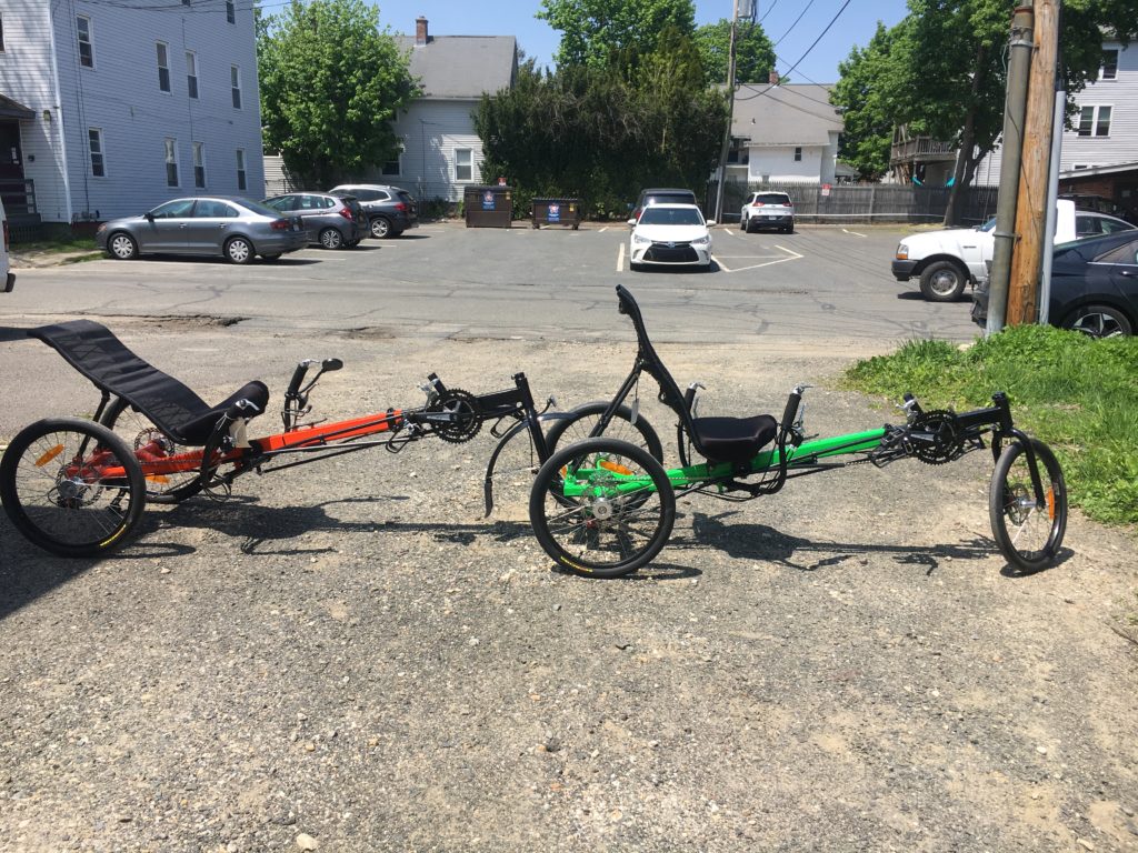 2 recumbent trikes attached to each other to make a tandem trike 