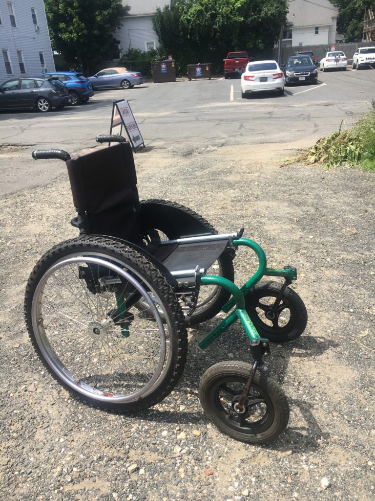 Side view of larger green wheelchair 
