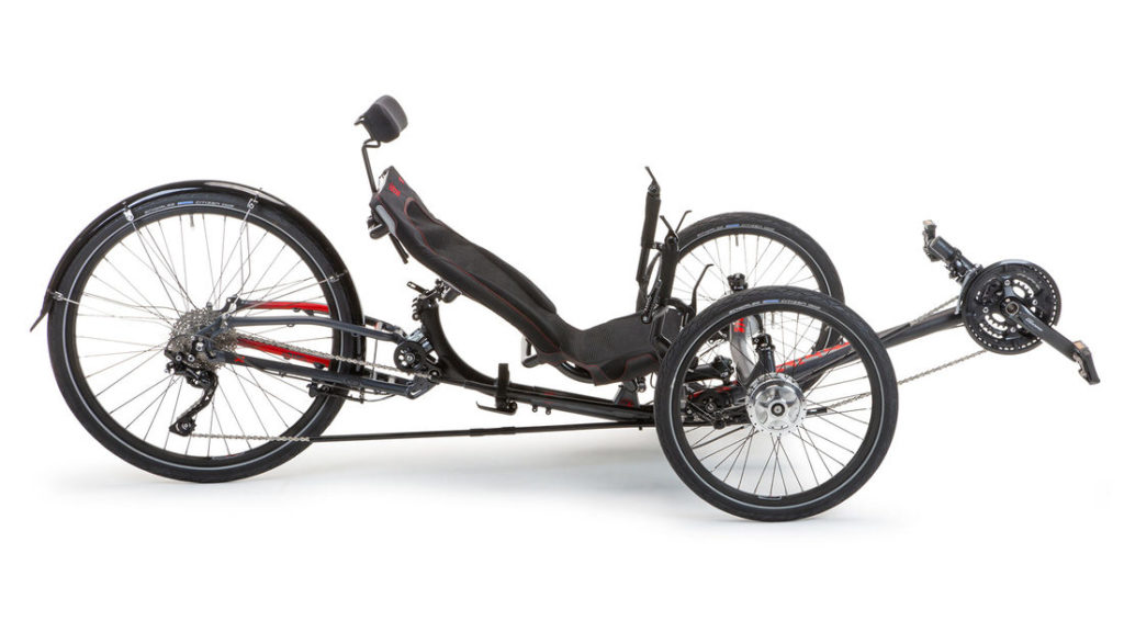 A black trike with red accents. There is a recumbent seat with a headrest, and one bigger wheel in the back and two smaller wheels in the front. 